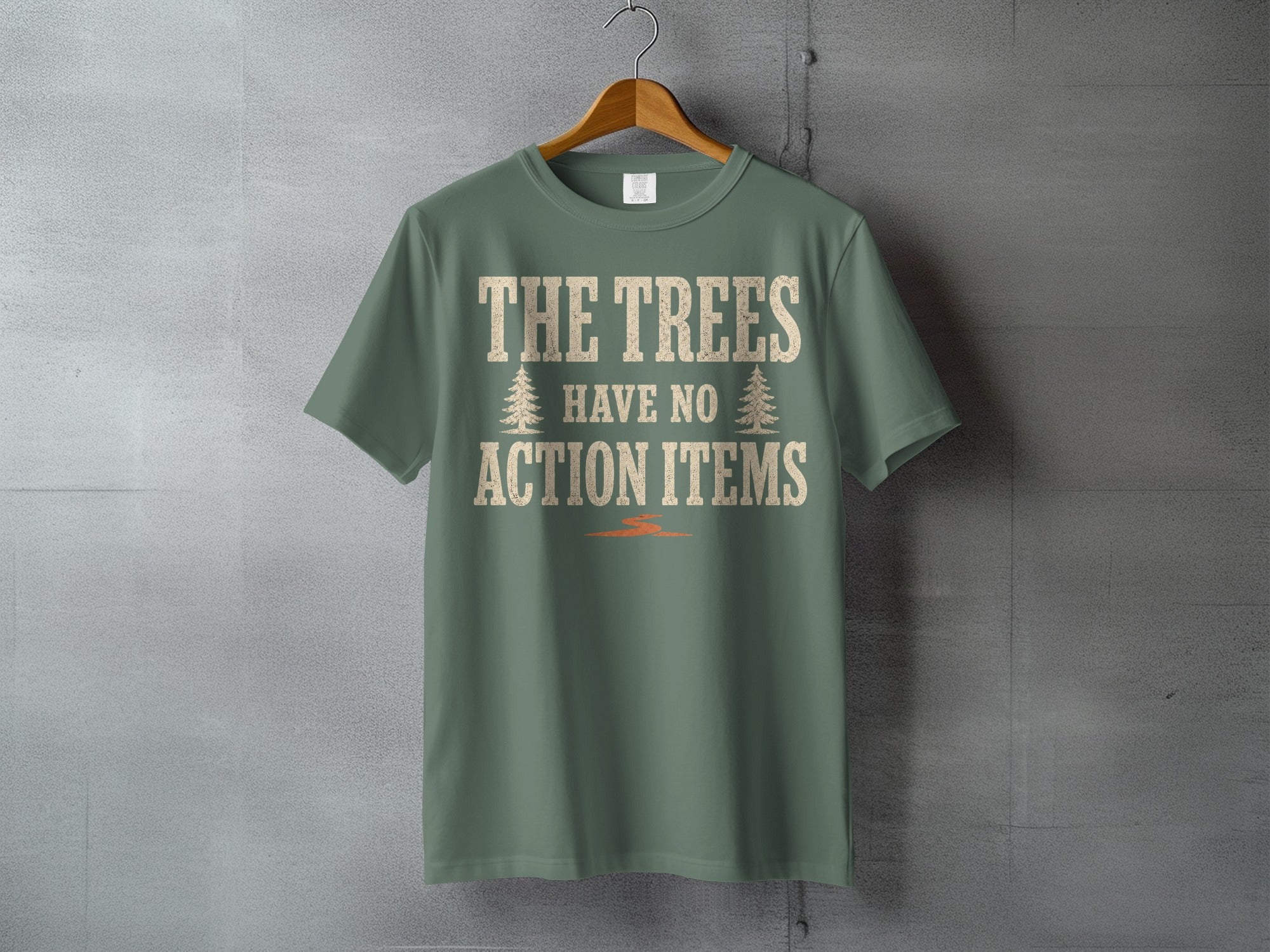 Green t-shirt with cream text reading "THE TREES HAVE NO ACTION ITEMS" and two tree icons.