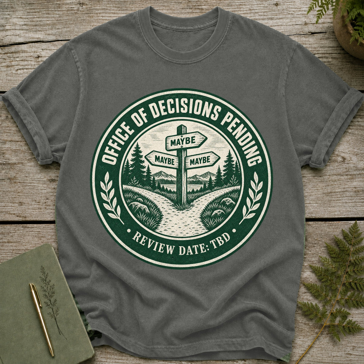 Gray t-shirt with "Office of Decisions Pending Review Date: TBD" and a crossroads sign.