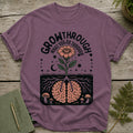 Purple t-shirt with graphic of brain roots, flower, moon, stars, and mushrooms.