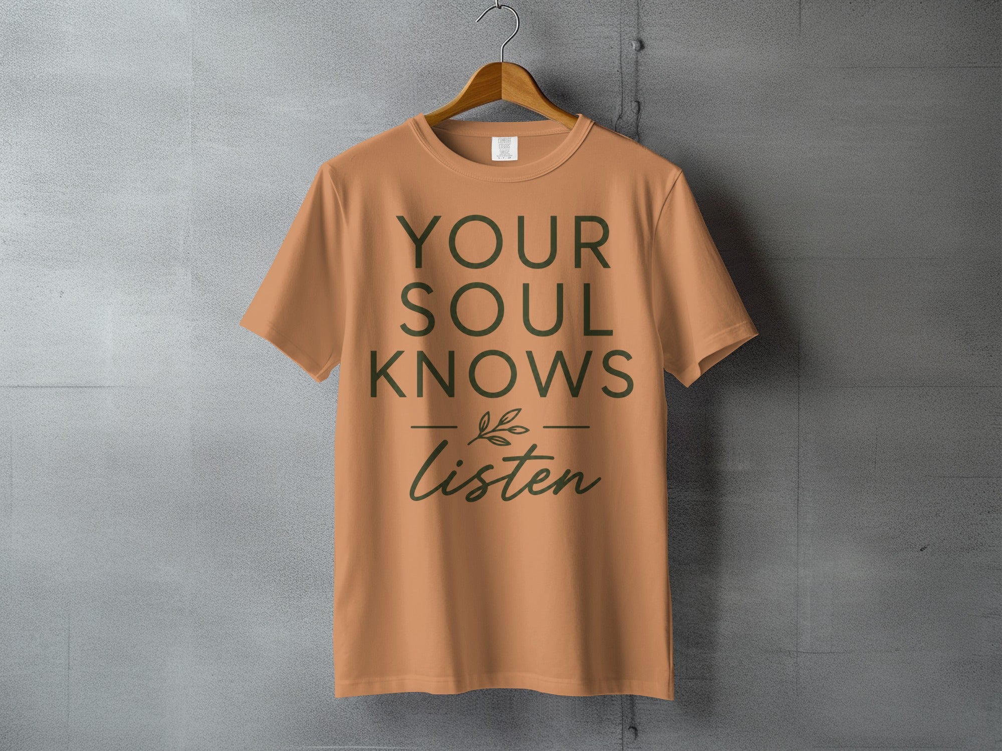 Orange t-shirt with "YOUR SOUL KNOWS Listen" text and a small leaf design.