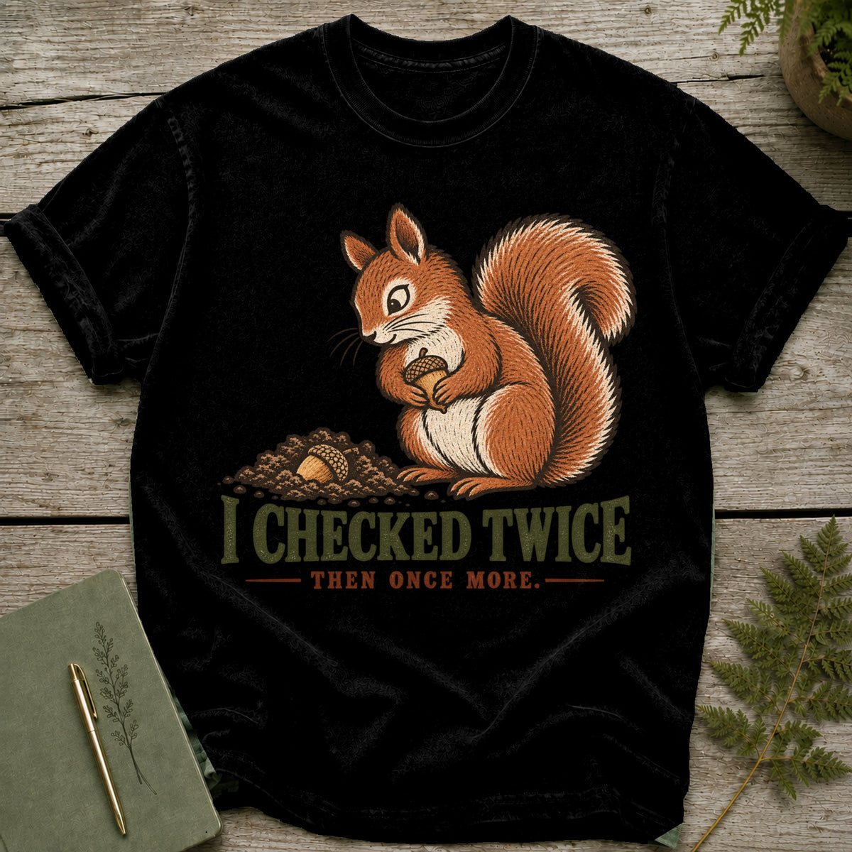 Black t-shirt with a squirrel holding an acorn and text "I CHECKED TWICE THEN ONCE MORE."