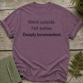 Purple t-shirt with black text "Went outside. Felt better. Deeply inconvenient."
