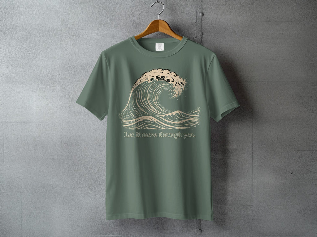 Green t-shirt with a stylized wave graphic and text "Let it move through you."