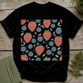 Black t-shirt with a repeating pattern of happy strawberries and blueberries.