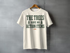 Cream t-shirt with dark green text "The Trees Have No Action Items" and two trees.