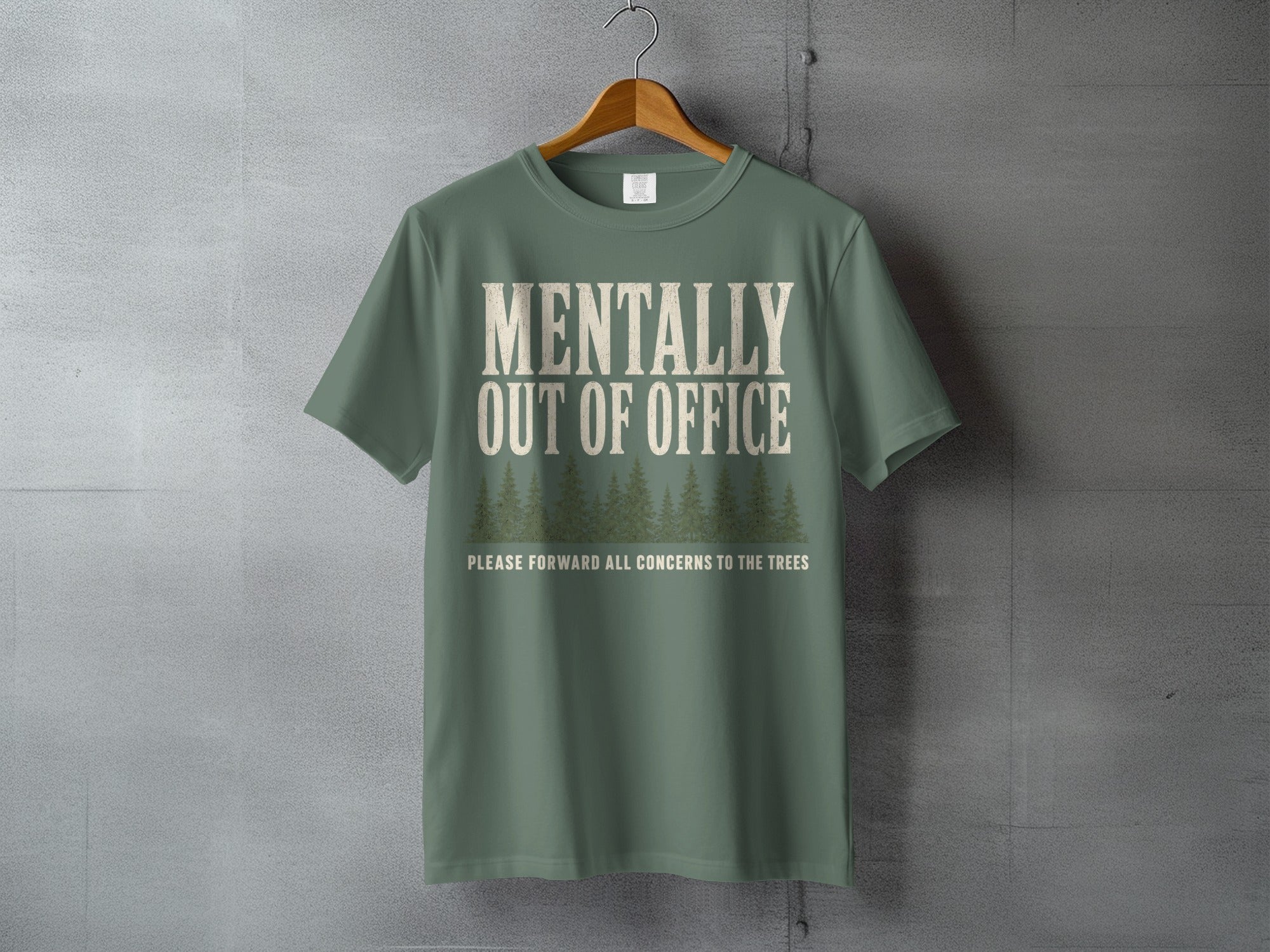 Green t-shirt with "MENTALLY OUT OF OFFICE" and trees graphic.
