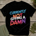 Black t-shirt with "Currently Not Giving A Damn" text in distressed, colorful lettering.