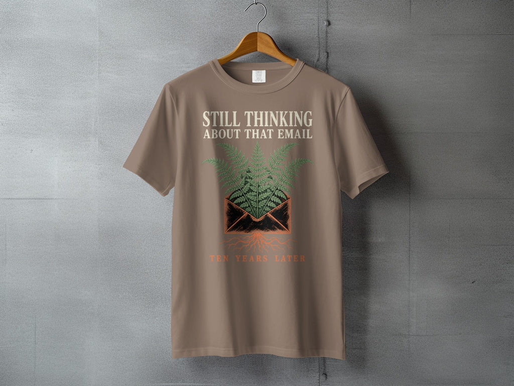 T-shirt with "Still Thinking About That Email Ten Years Later" text and fern design.