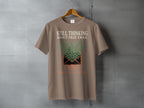 T-shirt with "Still Thinking About That Email Ten Years Later" text and fern design.