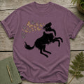 Black wolf silhouette leaping with a swirl of butterflies above it on a purple t-shirt.
