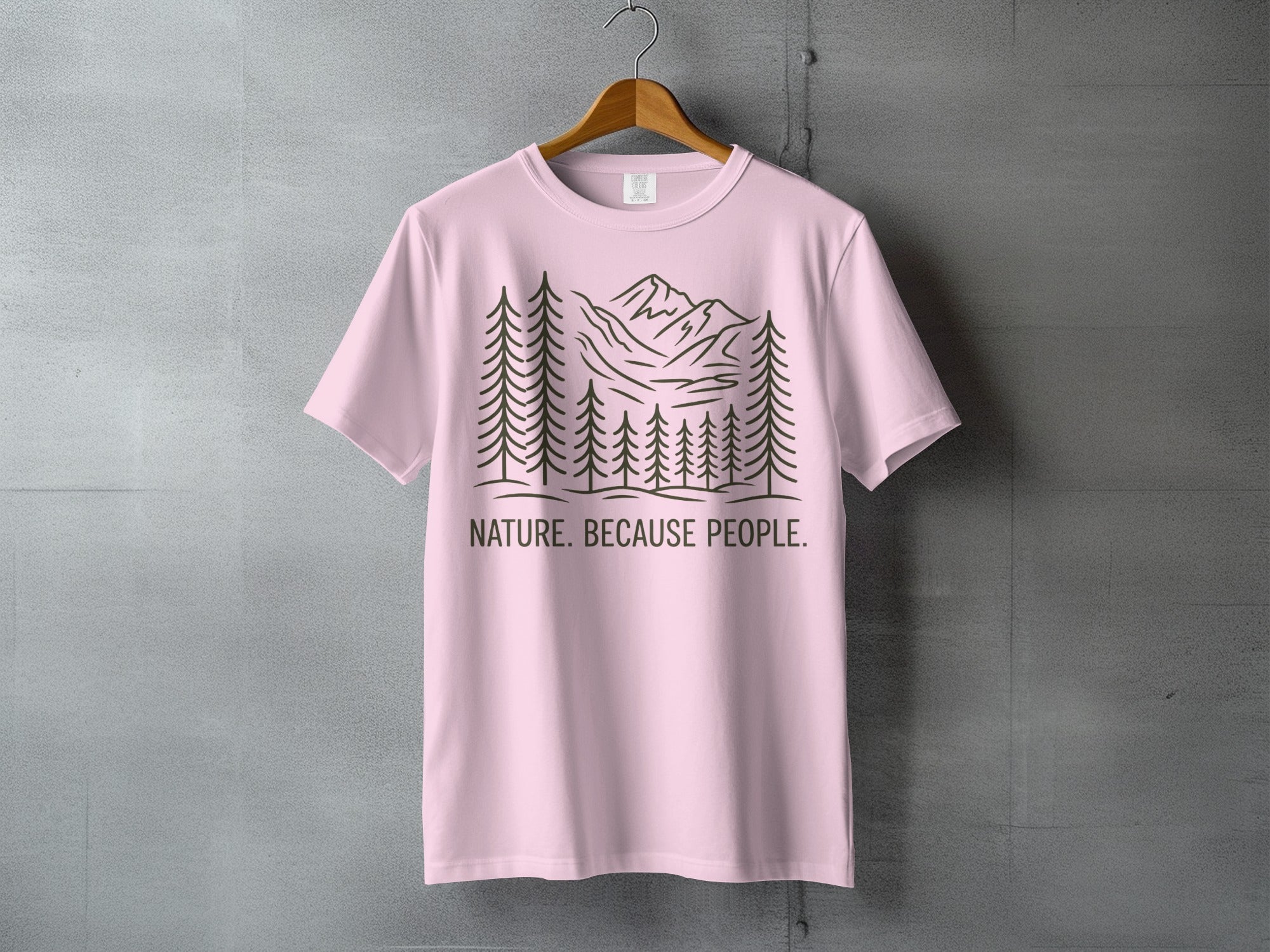 Pink t-shirt with trees, mountains, and "NATURE. BECAUSE PEOPLE." text.