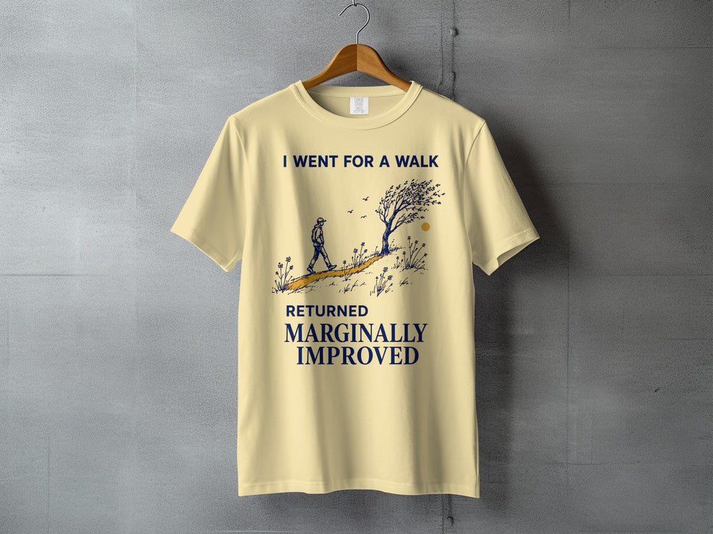 Cream t-shirt with a graphic of a person walking and text that reads "I WENT FOR A WALK RETURNED MARGINALLY IMPROVED."