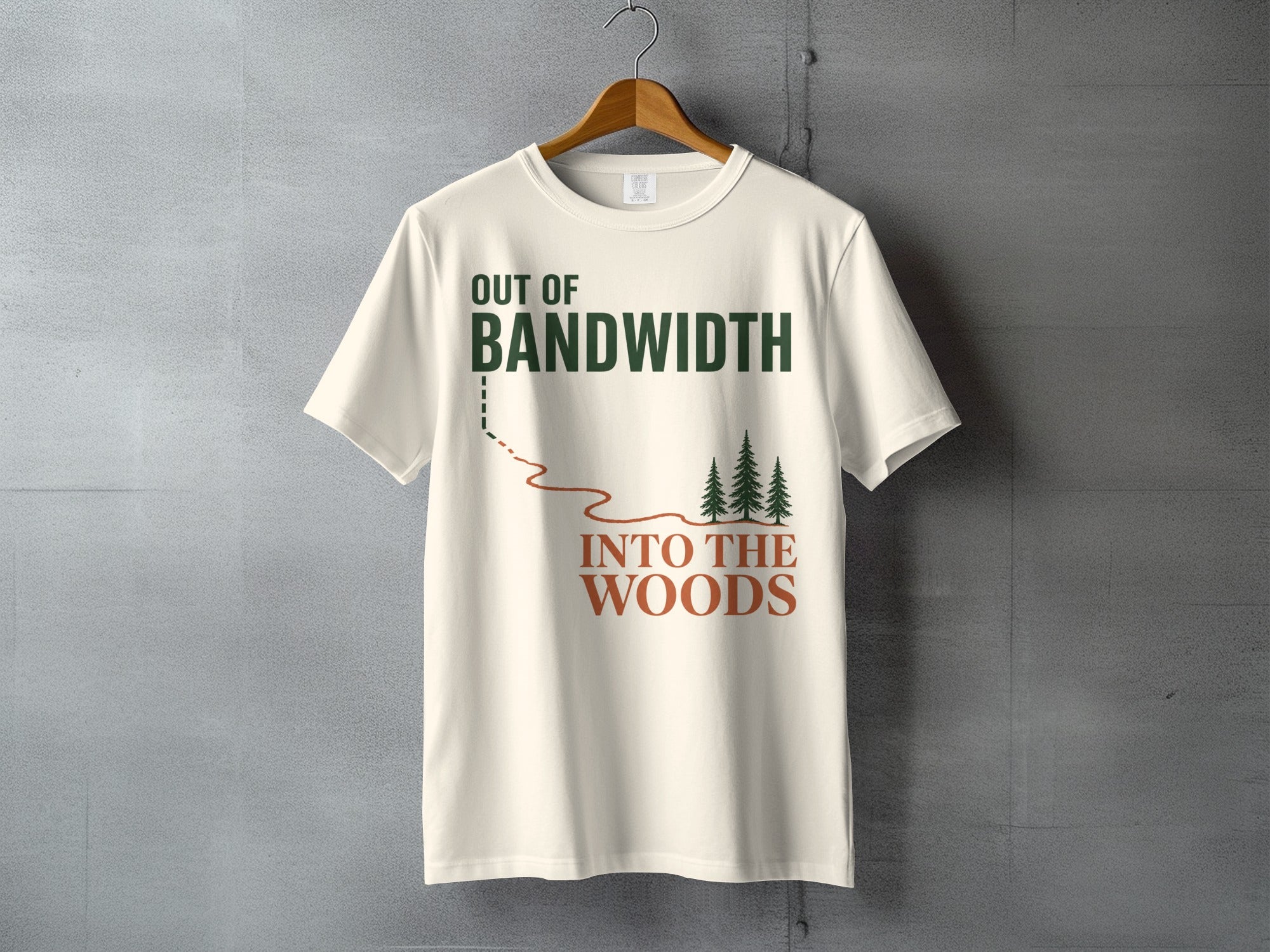 Cream t-shirt with text "OUT OF BANDWIDTH INTO THE WOODS" and a graphic of trees.