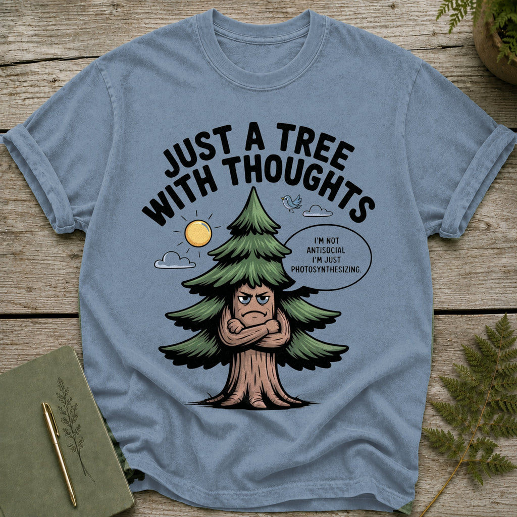 Blue t-shirt with grumpy tree graphic reading "Just a tree with thoughts."