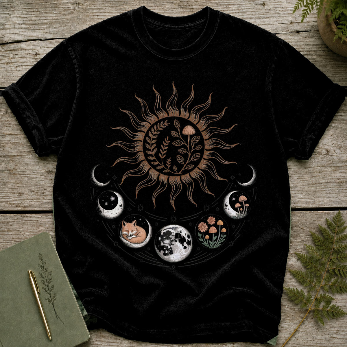 Black t-shirt featuring a sun with floral and mushroom designs and moon phases.