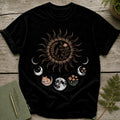 Black t-shirt featuring a sun with floral and mushroom designs and moon phases.