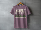 Purple t-shirt with "Mentally Out Of Office" and forest graphic.