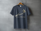 Dark grey t-shirt with a bird on a branch and text: "Still here Still moving."