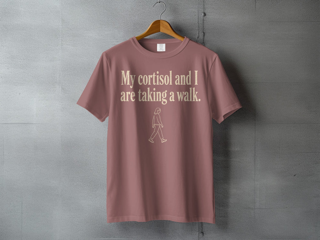 Brown t-shirt with "My cortisol and I are taking a walk." text and walking figure.