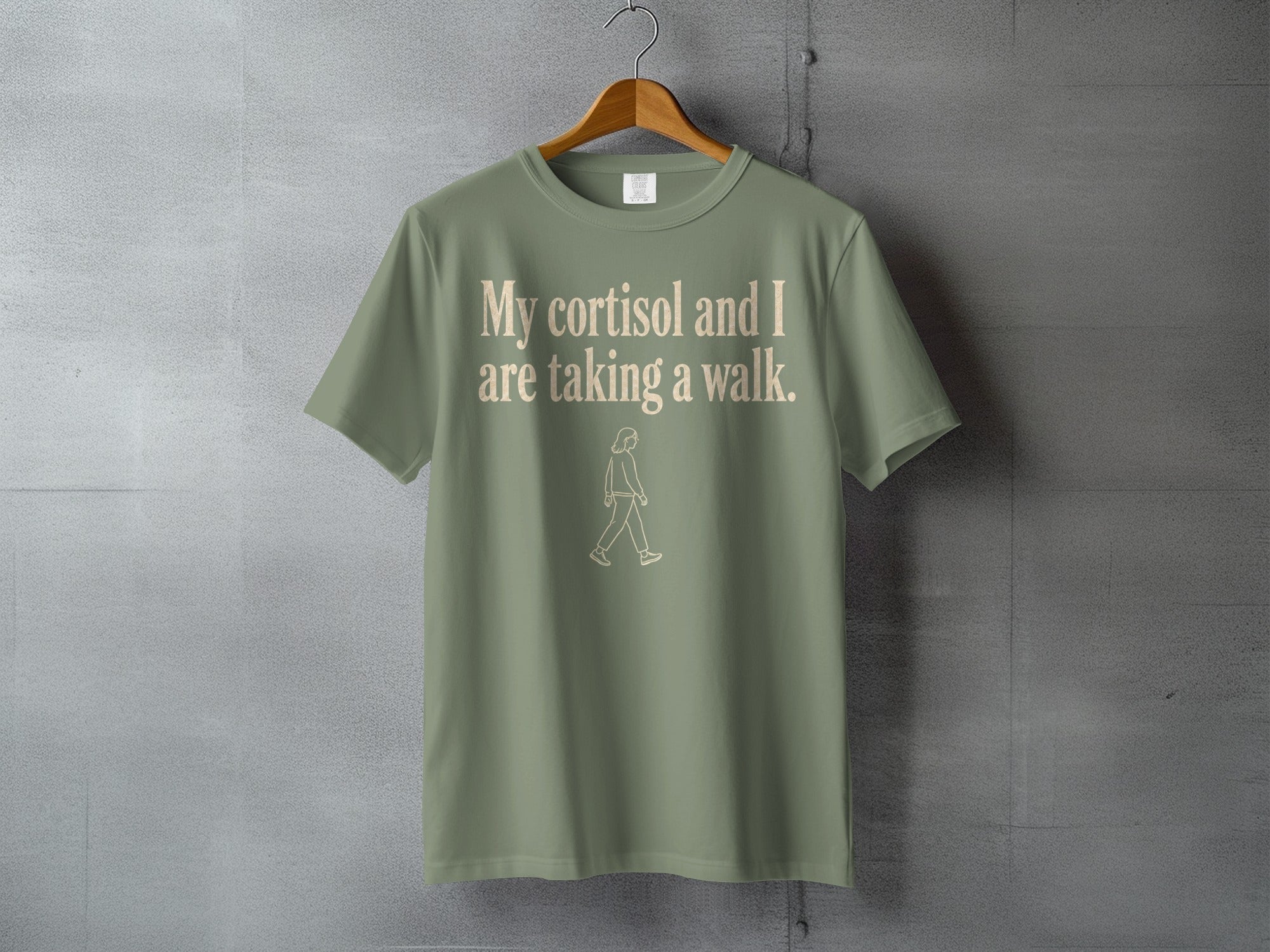 Green t-shirt with "My cortisol and I are taking a walk." text.