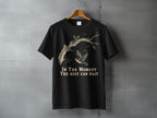Black t-shirt with a bird and tree branch design and text "IN THE MOMENT THE REST CAN WAIT".