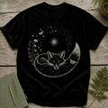 Black t-shirt with a white ink drawing of a sleeping fox surrounded by stars, mushrooms, and moths.