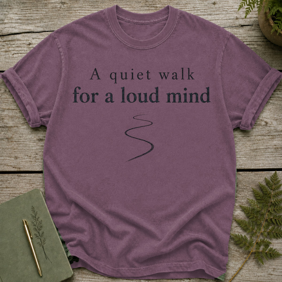 Purple t-shirt with "A quiet walk for a loud mind" text and winding path.