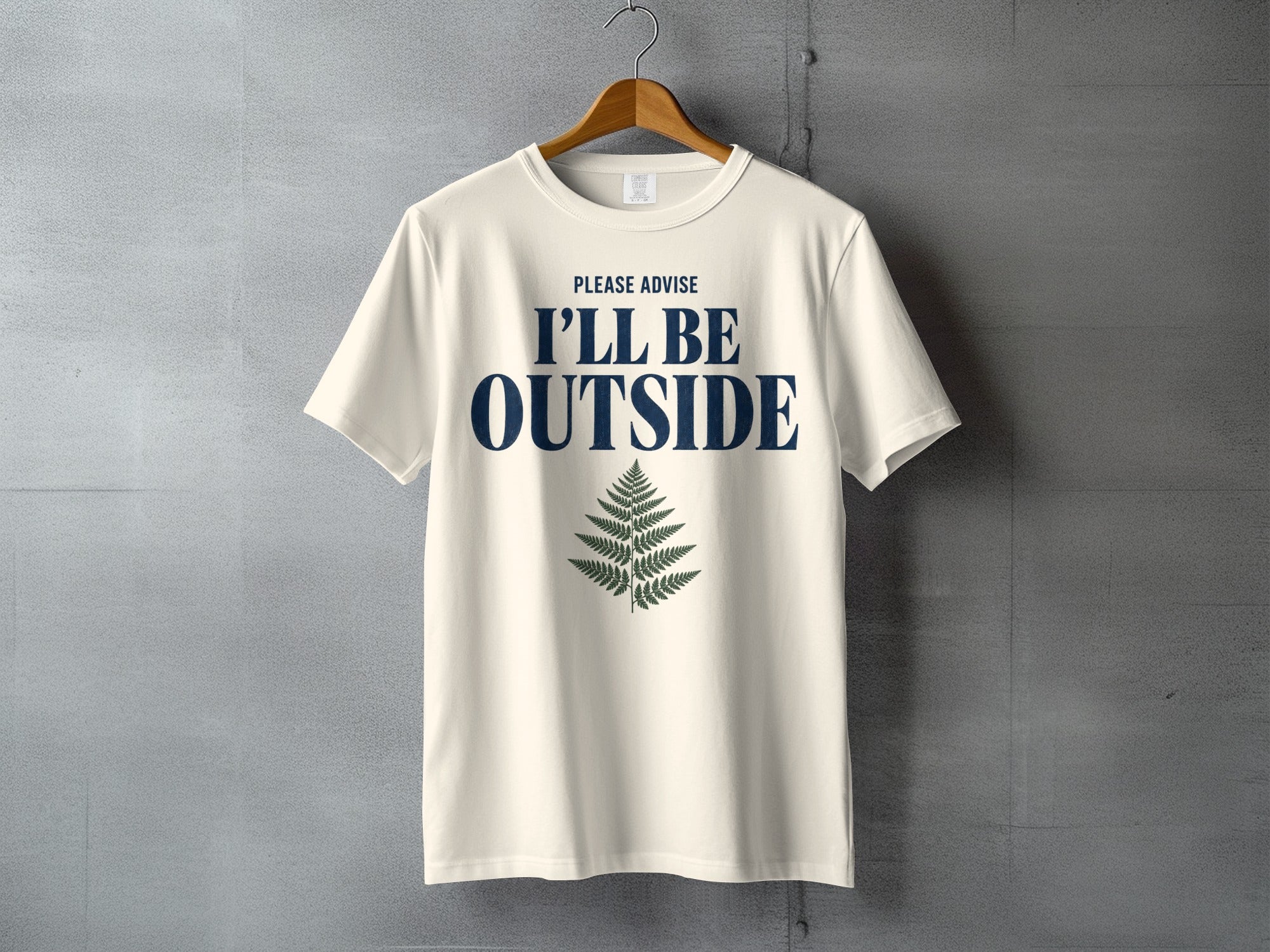 Cream t-shirt with text "PLEASE ADVISE I'LL BE OUTSIDE" and a fern graphic.