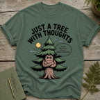 Green t-shirt with a cartoon tree with arms crossed and the text "Just a tree with thoughts".