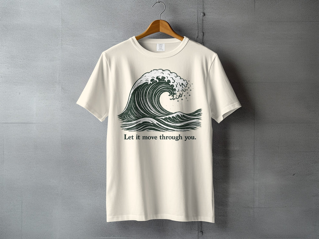 Cream t-shirt with a dark green wave graphic and the text "Let it move through you."