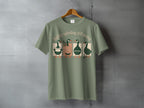 T-shirt with four ducks in a row, reading, with text "softly spiraling still moving".