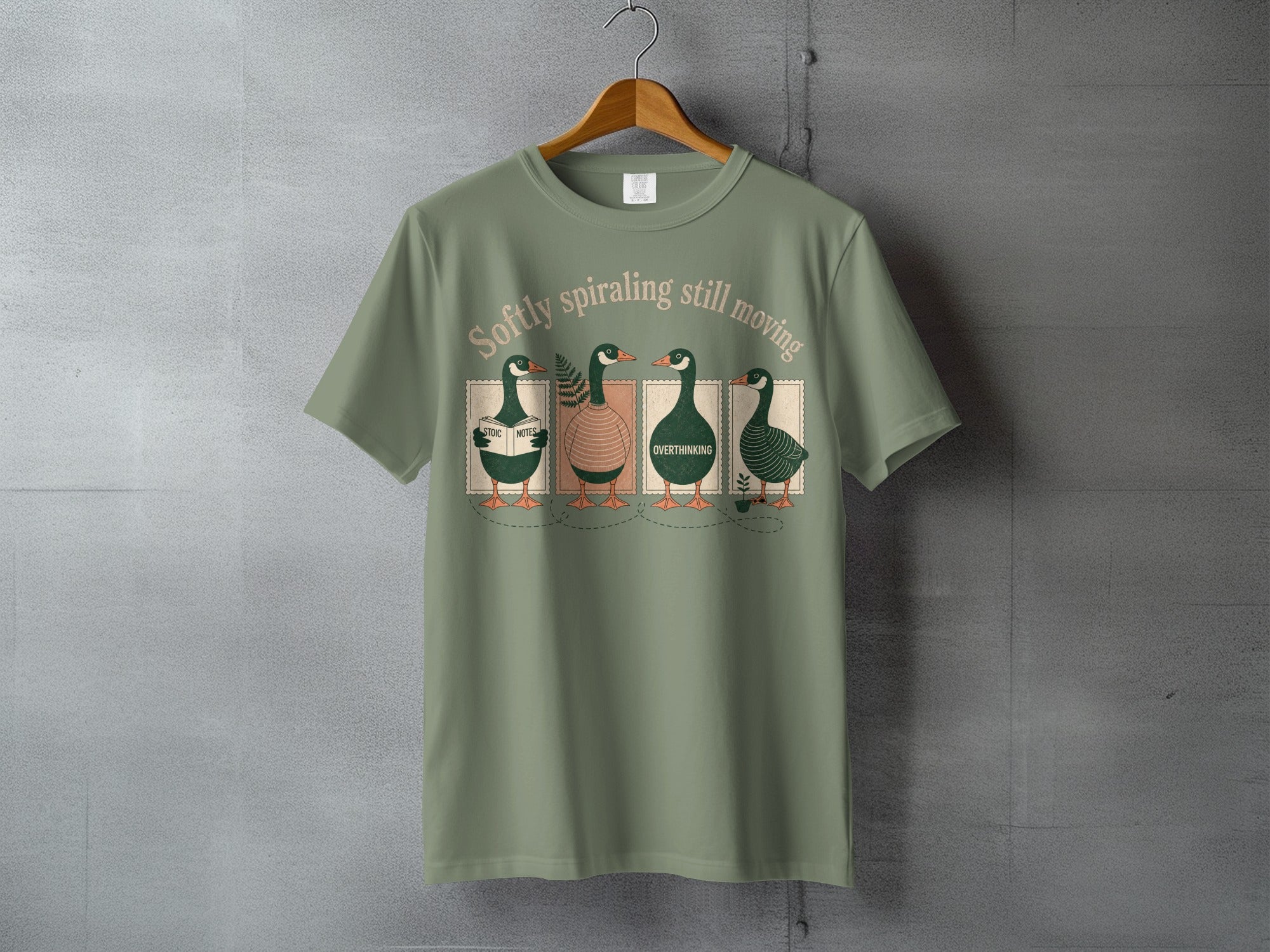 T-shirt with four ducks in a row, reading, with text "softly spiraling still moving".