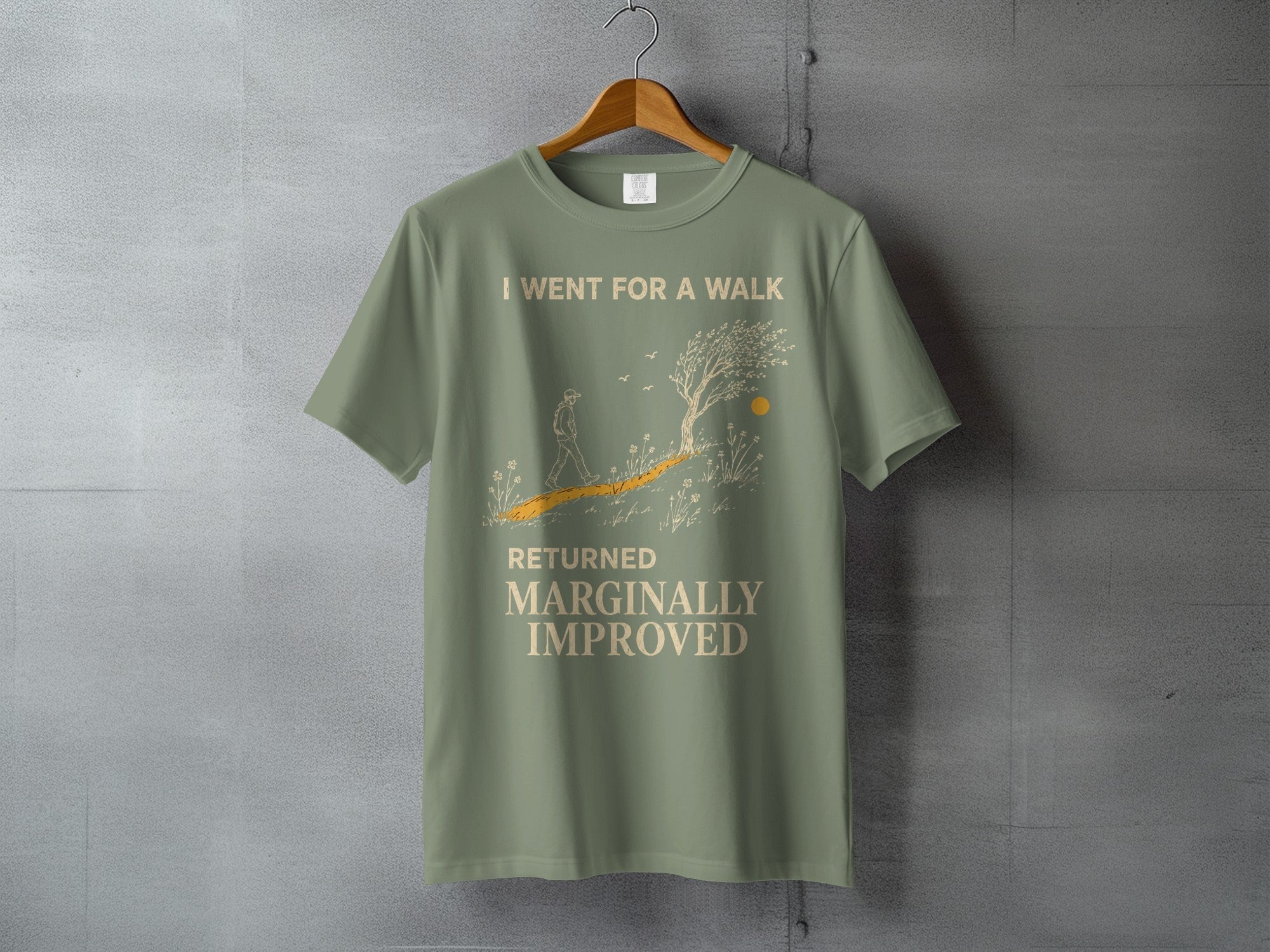 Green t-shirt with graphic and text "I went for a walk returned marginally improved".