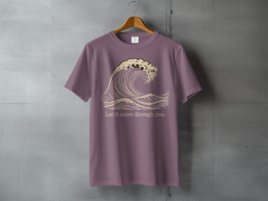 Purple t-shirt with a graphic of a breaking wave and the text "Let it move through you."