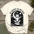 White t-shirt with a black graphic of a meditating fox, moon, stars, and mushrooms. Text reads "AS ABOVE SO WITHIN."