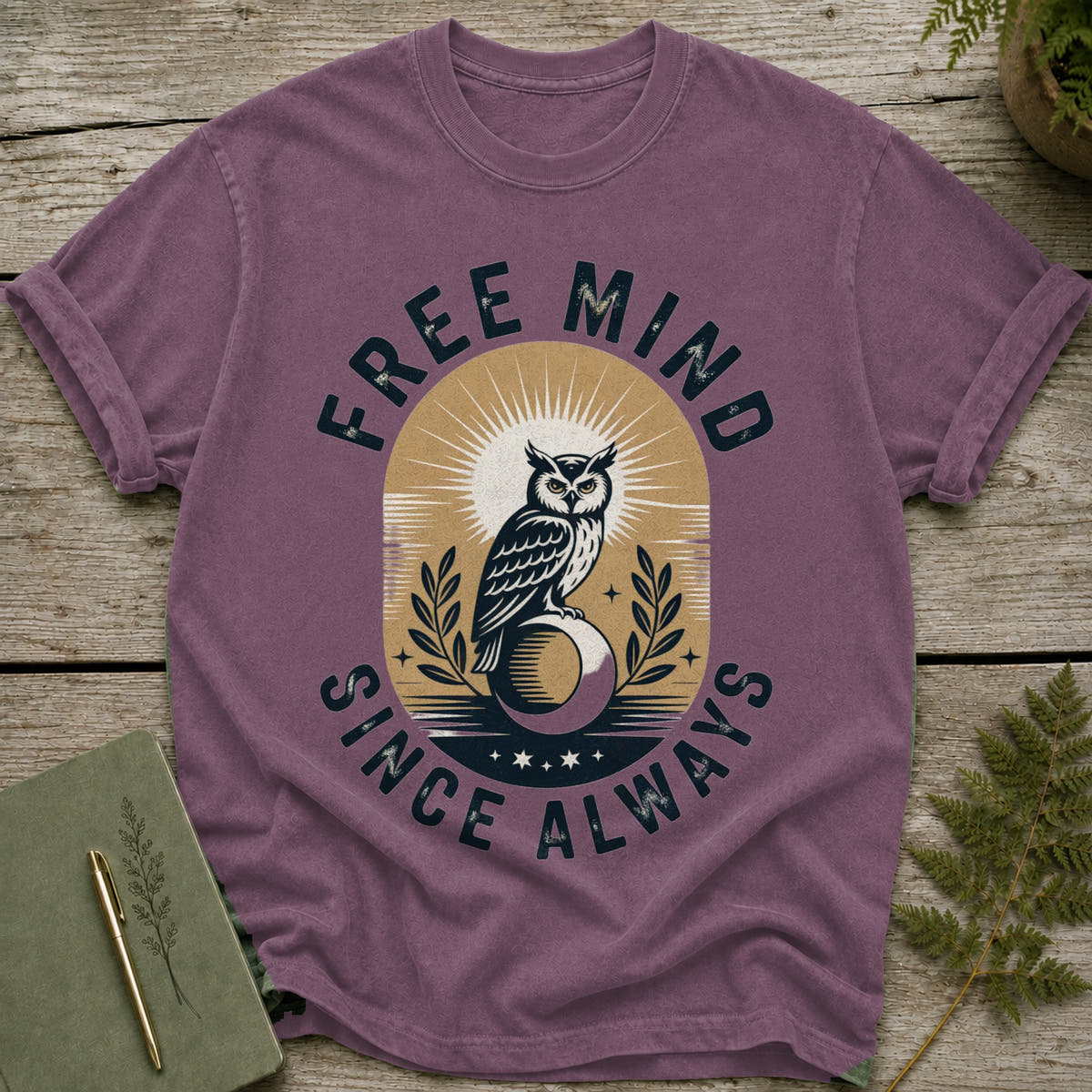 Purple t-shirt with owl graphic and text "FREE MIND SINCE ALWAYS".