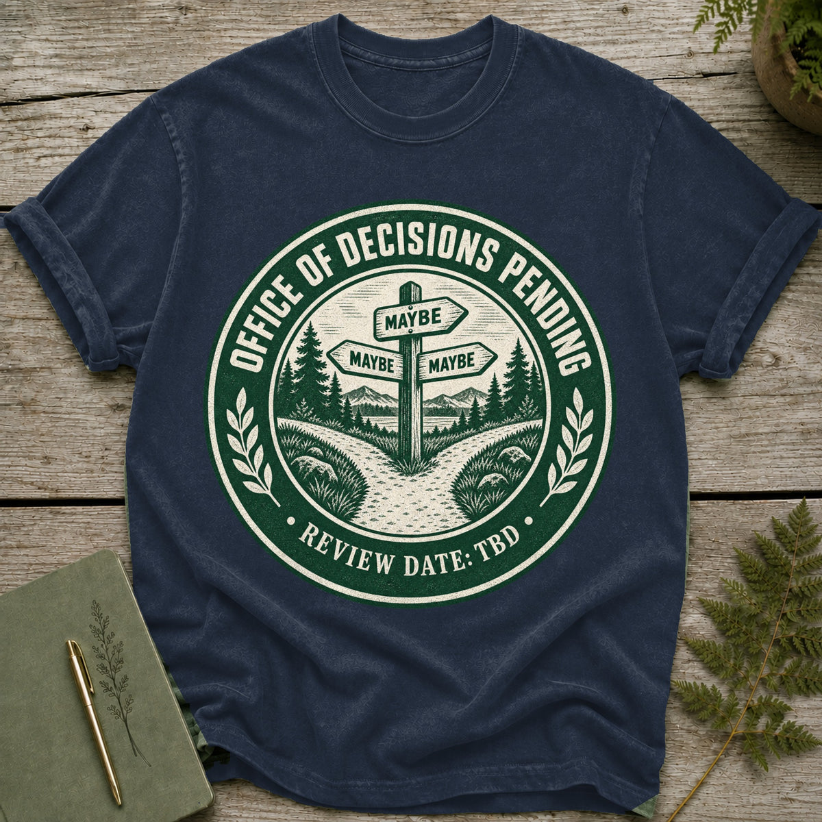 Navy t-shirt with "Office of Decisions Pending Review Date: TBD" text and signpost.