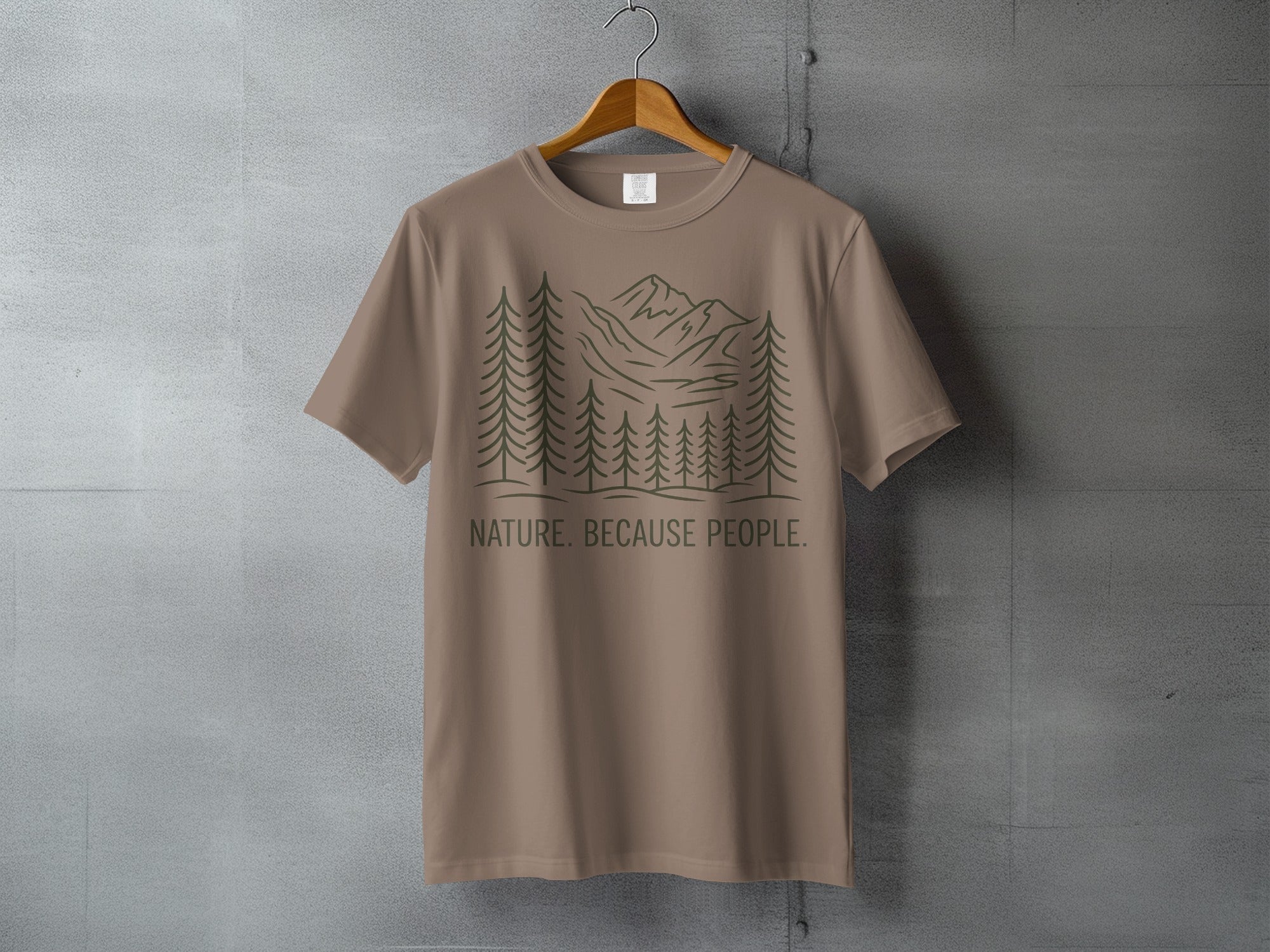 Brown t-shirt with forest and mountain graphic and text "NATURE. BECAUSE PEOPLE."
