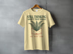 Light yellow t-shirt with "Still Thinking About That Email" and ferns.