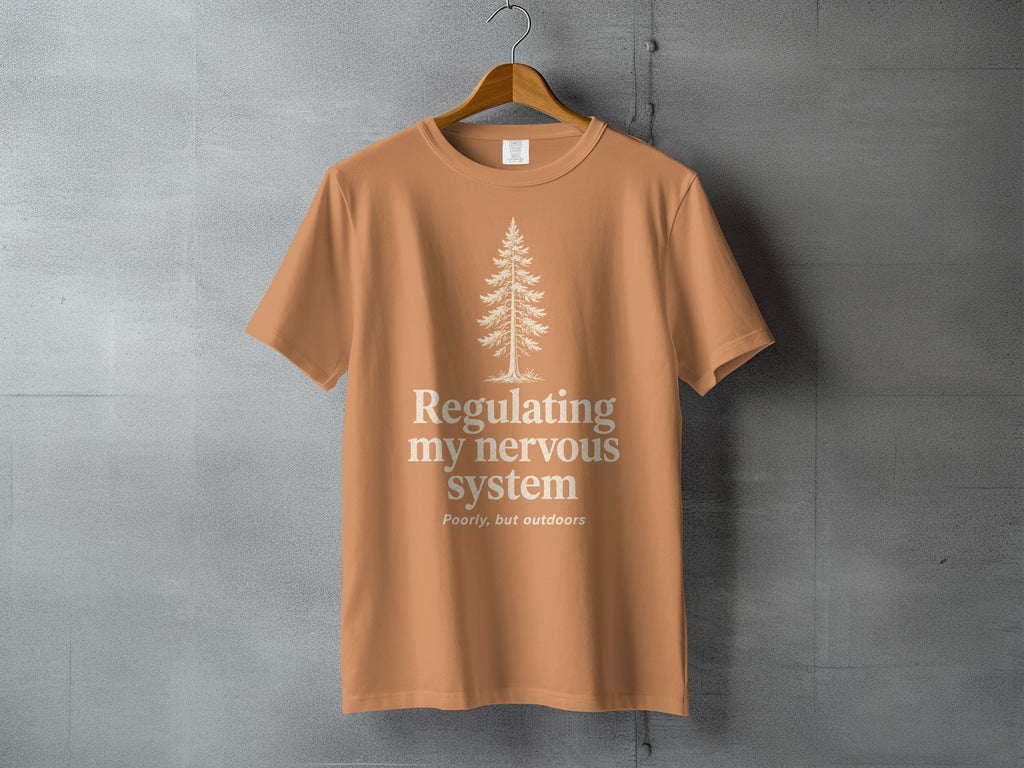 Orange t-shirt with a pine tree graphic and "Regulating my nervous system" text.