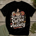 Black t-shirt with "Fueled by Coffee and Anxiety" text and floral design.