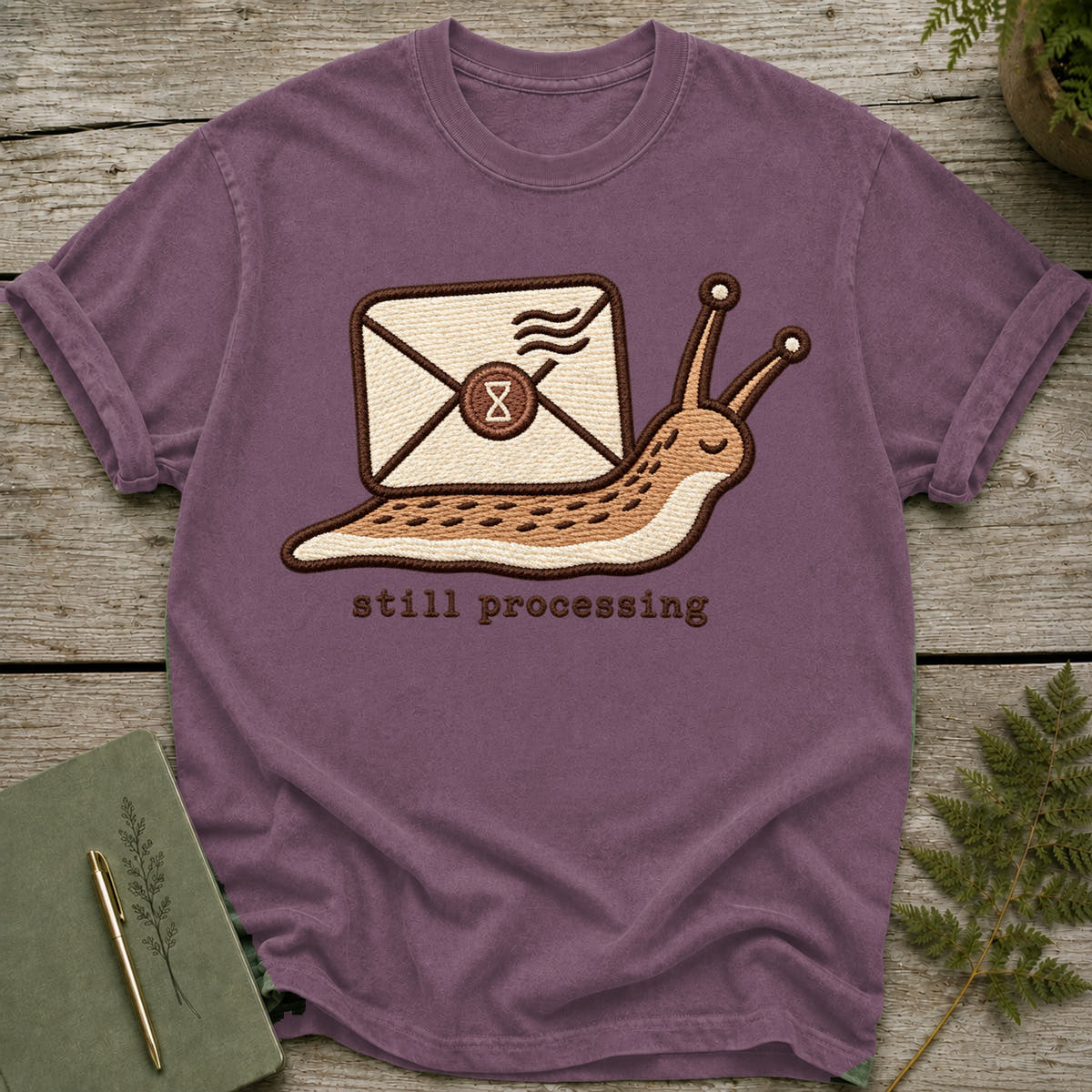 Embroidered slug carrying an envelope with "still processing" text below.