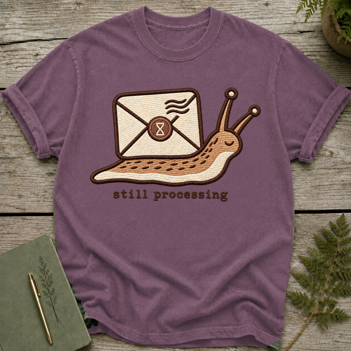 Embroidered slug carrying an envelope with "still processing" text below.