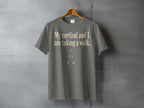 Grey t-shirt with text "My cortisol and I are taking a walk." and a walking figure.