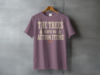 Purple t-shirt with distressed text "THE TREES HAVE NO ACTION ITEMS".