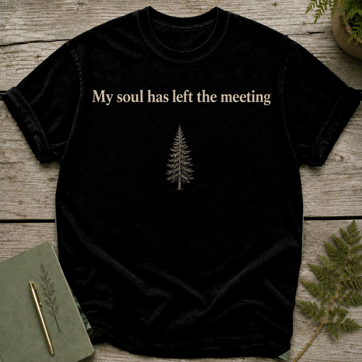 Black t-shirt with text "My soul has left the meeting" and a pine tree graphic.