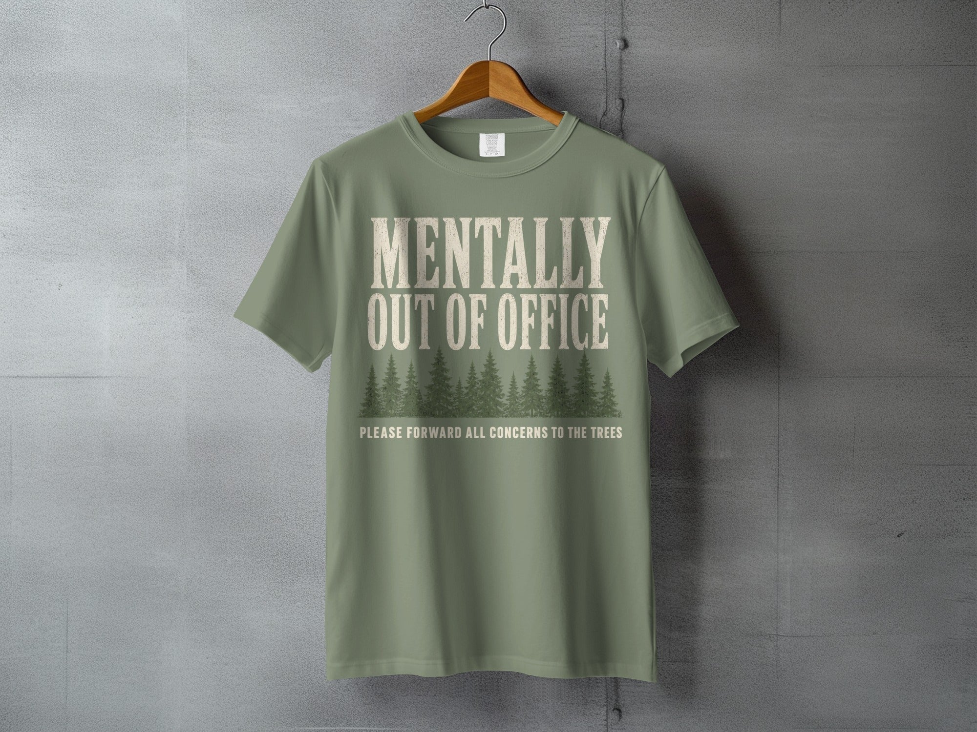 Green t-shirt with "MENTALLY OUT OF OFFICE" and trees graphic.