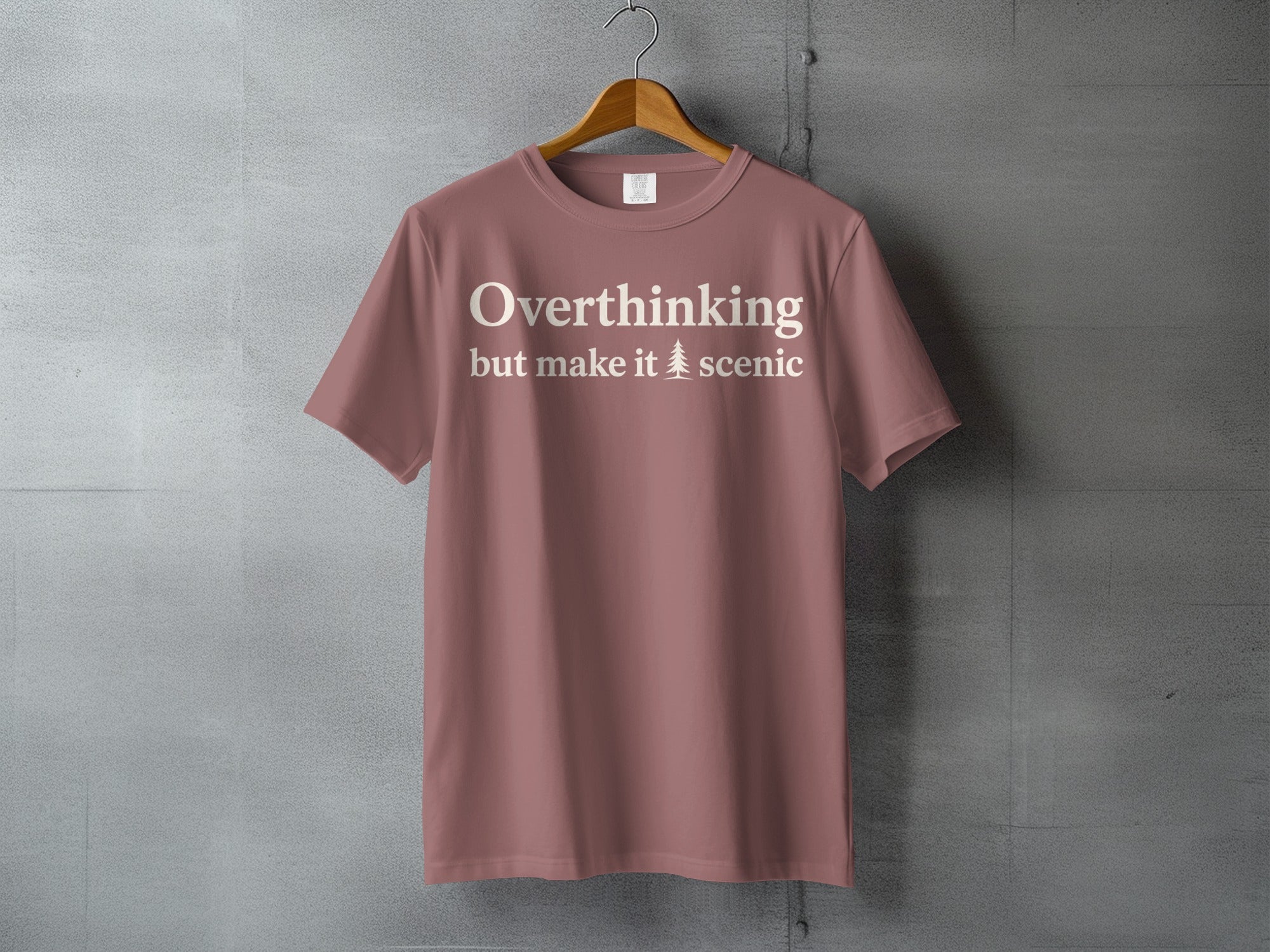 Rose t-shirt with white text "Overthinking but make it scenic" and a tree icon.