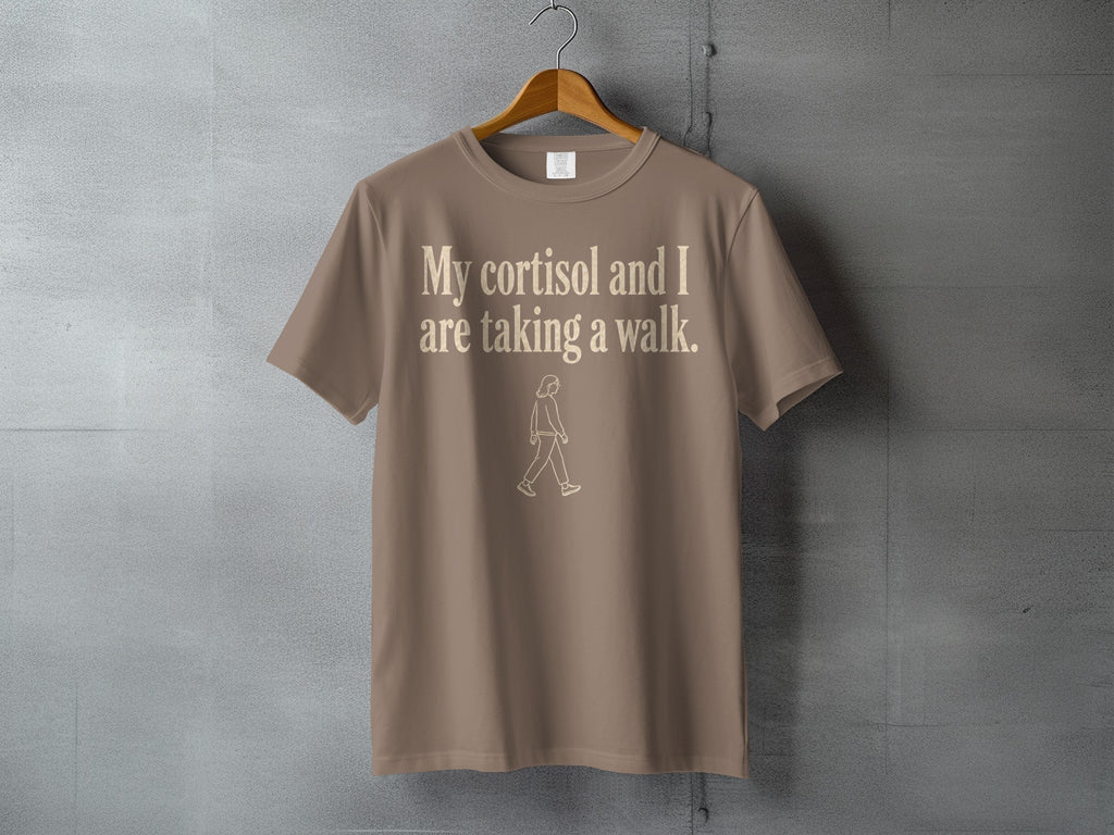 Tan t-shirt with "My cortisol and I are taking a walk" text and walking figure.