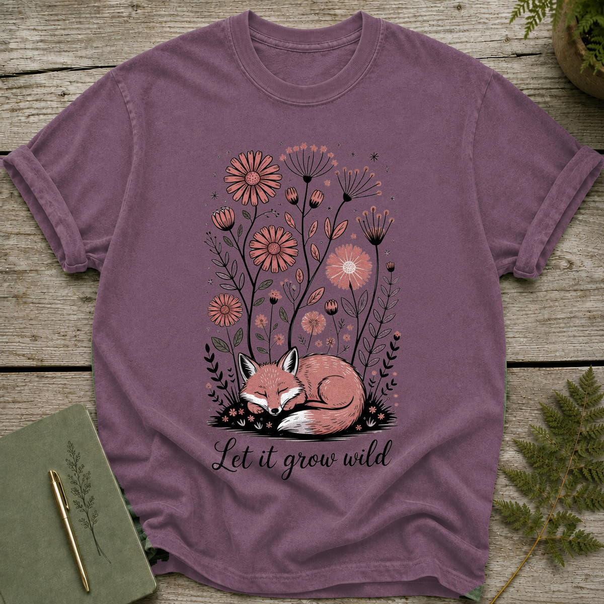 T-shirt with sleeping fox and flowers, reads "Let it grow wild."